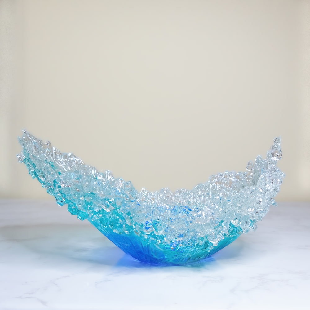 Abstract resin sculpture with white crystal-like tips and a blue base.
